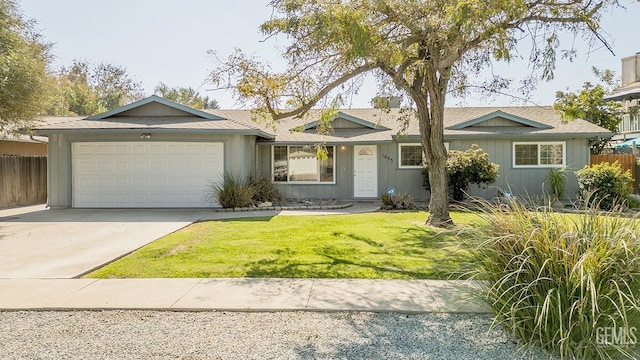 ranch-style home with a garage and a front lawn