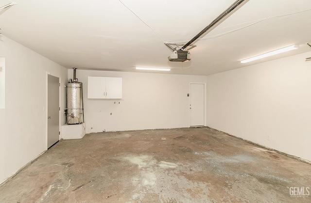 garage with water heater and a garage door opener