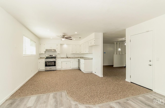 kitchen featuring white cabinets, sink, ceiling fan, light wood-type flooring, and stainless steel appliances