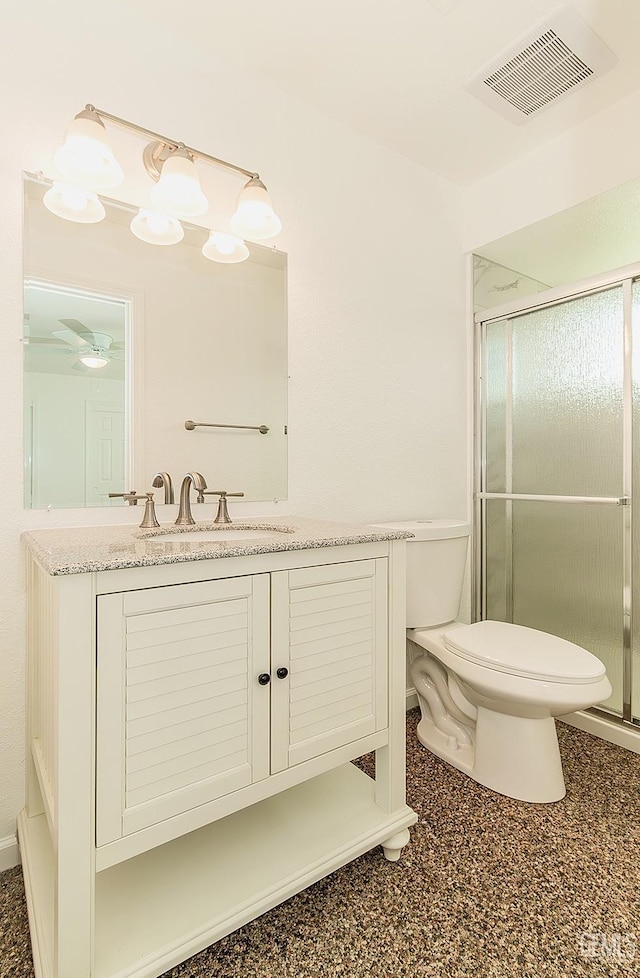 bathroom featuring toilet, vanity, and walk in shower