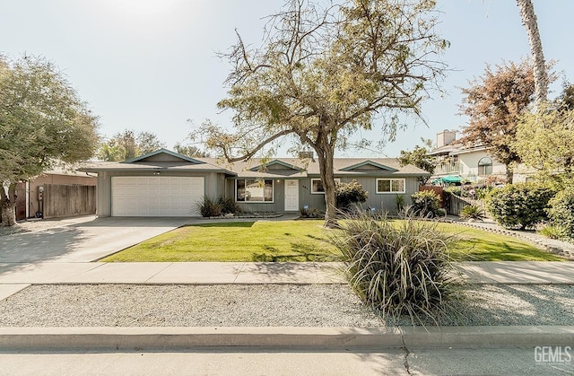 view of front of home with a garage and a front lawn