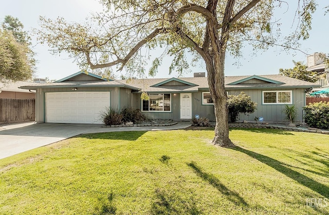 single story home with a garage and a front lawn