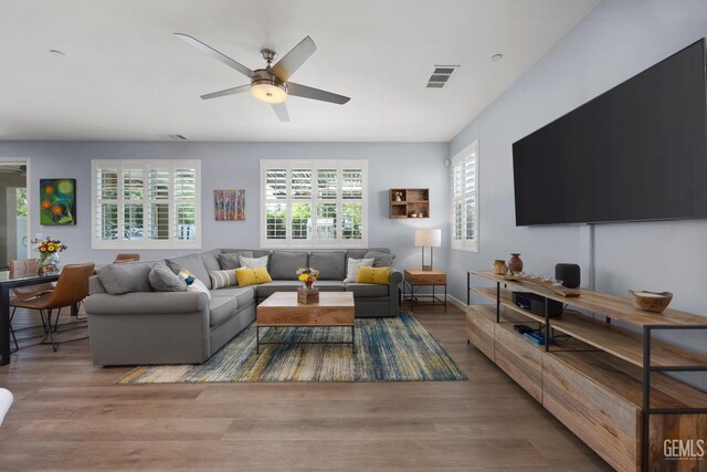8113 Mcgraw Hill Dr, Bakersfield, CA 93311 - living room with wood finished floors, visible vents, and a ceiling fan