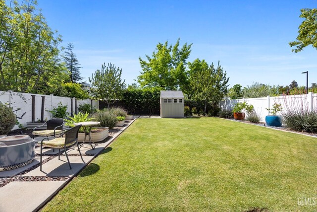 8113 Mcgraw Hill Dr, Bakersfield, CA 93311 - view of yard with an outdoor structure, a patio area, a shed, and a fenced backyard