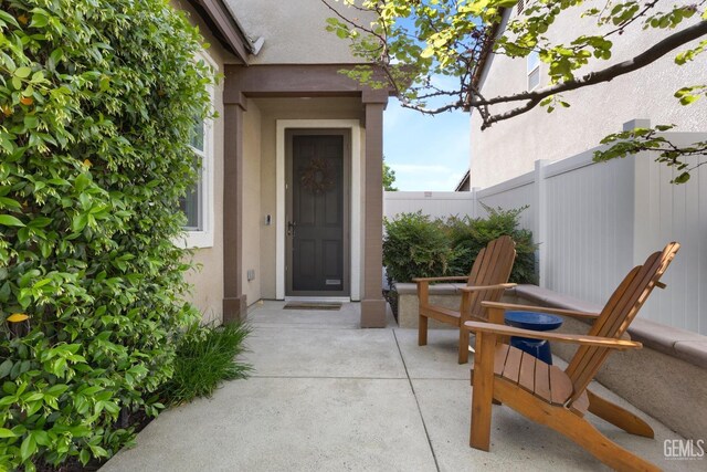 8113 Mcgraw Hill Dr, Bakersfield, CA 93311 - entrance to property featuring stucco siding, fence, and a patio area