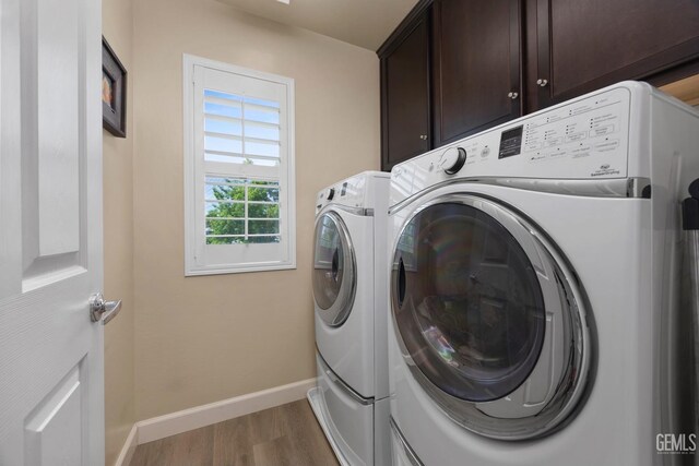 8113 Mcgraw Hill Dr, Bakersfield, CA 93311 - washroom featuring cabinet space, wood finished floors, baseboards, and washer and clothes dryer