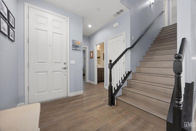 8113 Mcgraw Hill Dr, Bakersfield, CA 93311 - entrance foyer featuring recessed lighting, wood finished floors, visible vents, baseboards, and stairs
