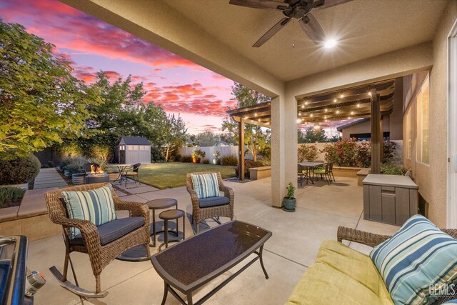 8113 Mcgraw Hill Dr, Bakersfield, CA 93311 - patio terrace at dusk with outdoor lounge area, a fenced backyard, a storage shed, an outdoor structure, and outdoor dining area