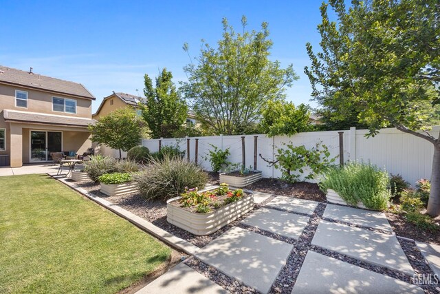 8113 Mcgraw Hill Dr, Bakersfield, CA 93311 - view of yard featuring a fenced backyard, a garden, and a patio