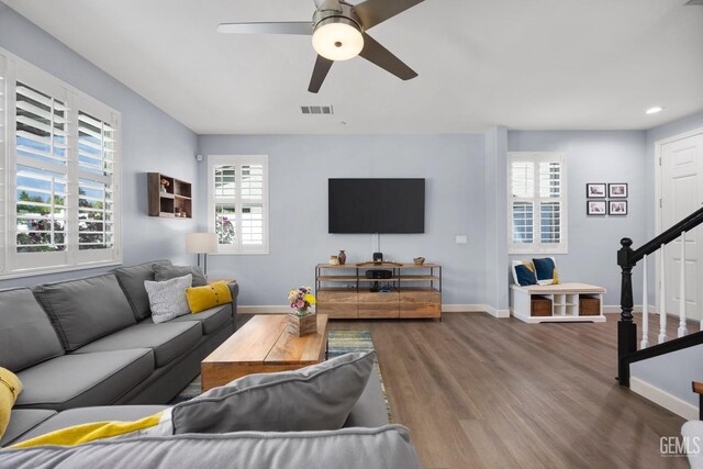 8113 Mcgraw Hill Dr, Bakersfield, CA 93311 - living area with baseboards, wood finished floors, visible vents, and stairs