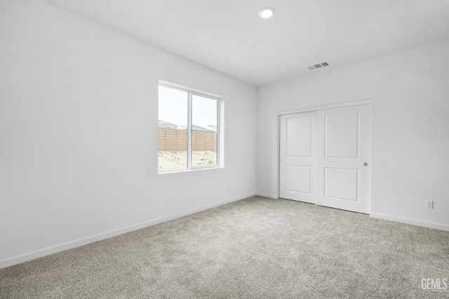 unfurnished bedroom with carpet floors and a closet