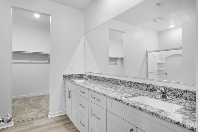 bathroom featuring vanity and hardwood / wood-style flooring