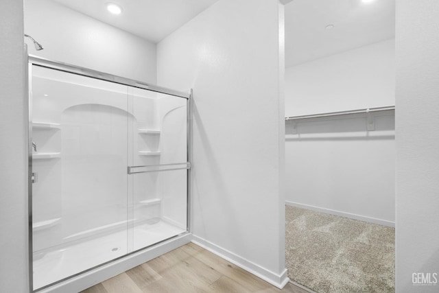 bathroom featuring hardwood / wood-style floors and an enclosed shower