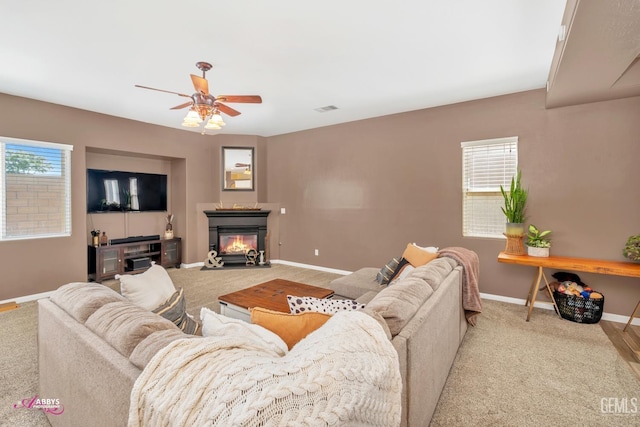 22 Emerald Isle Way, Bakersfield, CA 93314 - carpeted living room with plenty of natural light, a glass covered fireplace, baseboards, visible vents, and ceiling fan