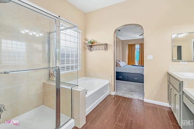 22 Emerald Isle Way, Bakersfield, CA 93314 - bathroom featuring a bath, vanity, wood tiled floor, a shower stall, and ensuite bath