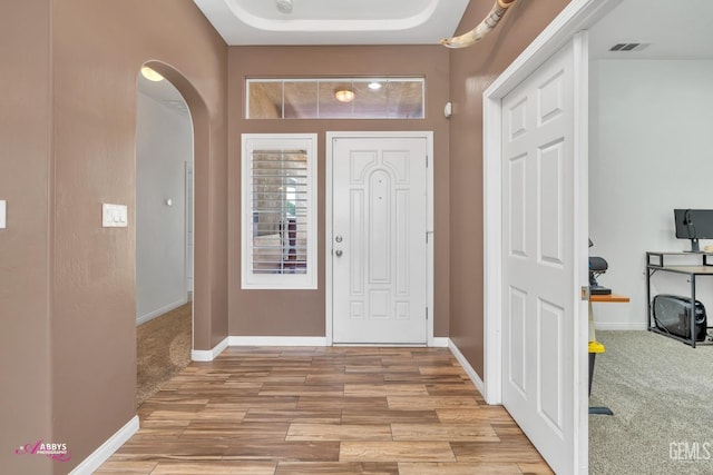 22 Emerald Isle Way, Bakersfield, CA 93314 - foyer entrance with arched walkways, light wood-style floors, visible vents, and baseboards