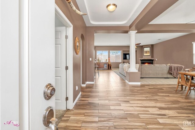 22 Emerald Isle Way, Bakersfield, CA 93314 - foyer entrance with baseboards, a lit fireplace, ornate columns, and light wood-style flooring