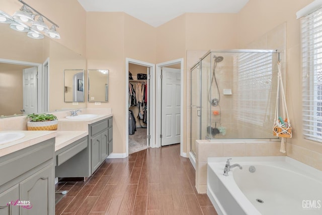 22 Emerald Isle Way, Bakersfield, CA 93314 - full bath featuring a garden tub, vanity, a walk in closet, and a stall shower