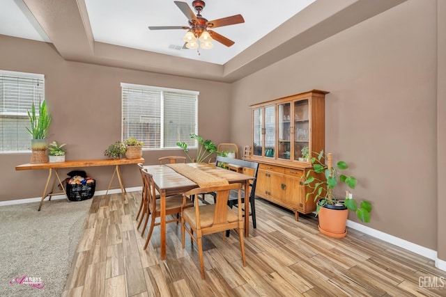 22 Emerald Isle Way, Bakersfield, CA 93314 - dining space with a raised ceiling, light wood-type flooring, a ceiling fan, and baseboards