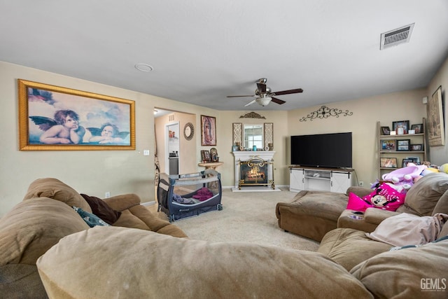 9301 Cobble Mountain Rd, Bakersfield, CA 93313 - living room with carpet floors, a ceiling fan, a lit fireplace, and baseboards