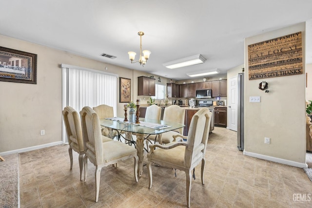 9301 Cobble Mountain Rd, Bakersfield, CA 93313 - dining space featuring a chandelier and baseboards