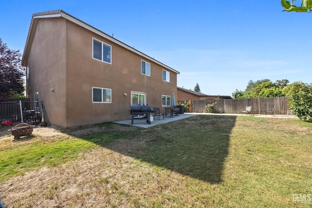 9301 Cobble Mountain Rd, Bakersfield, CA 93313 - back of property with a patio, stucco siding, and an outdoor fire pit