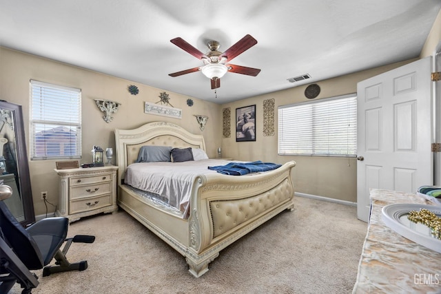 9301 Cobble Mountain Rd, Bakersfield, CA 93313 - bedroom featuring multiple windows, light colored carpet, baseboards, and ceiling fan