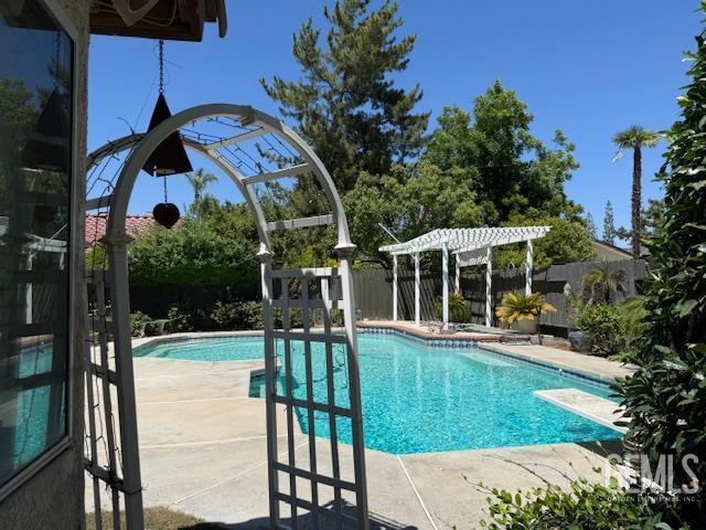 2012 Calle Las Brisas, Bakersfield, CA 93309 - view of pool with a fenced backyard, a patio area, a diving board, and a pergola