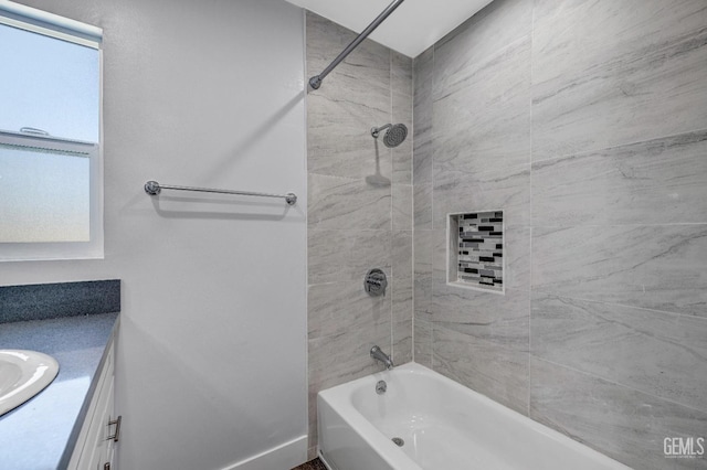 bathroom featuring vanity and tiled shower / bath combo