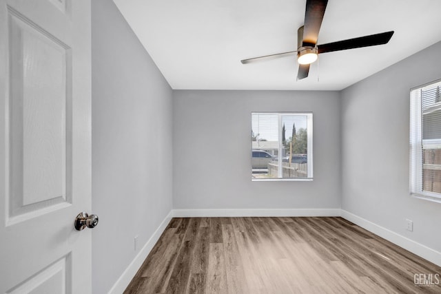 empty room with ceiling fan and light hardwood / wood-style floors