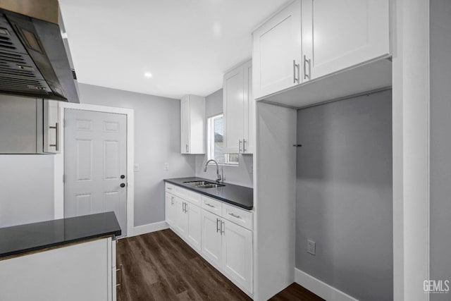 kitchen featuring white cabinets, sink, dark hardwood / wood-style floors, and range hood