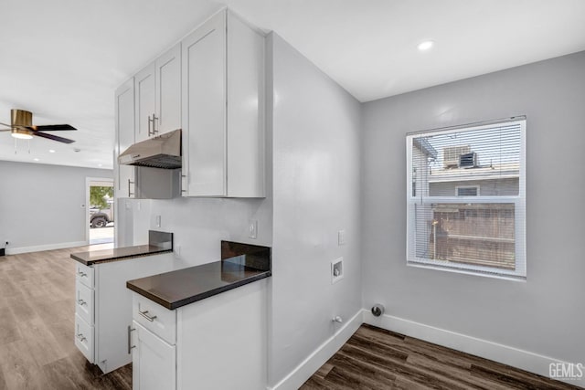 kitchen with dark hardwood / wood-style flooring, white cabinetry, and ceiling fan