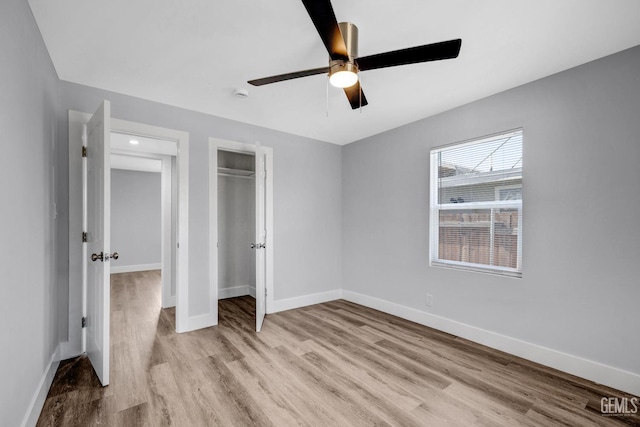 unfurnished bedroom featuring ceiling fan, a closet, and light hardwood / wood-style flooring