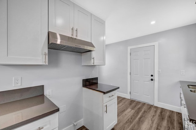 kitchen with white cabinetry and light hardwood / wood-style floors