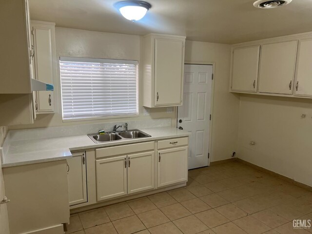 1026 Flower St, Bakersfield, CA 93305 - kitchen featuring white cabinetry, light tile patterned floors, and light countertops