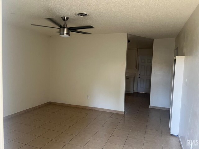 1026 Flower St, Bakersfield, CA 93305 - spare room with ceiling fan, light tile patterned floors, and a textured ceiling