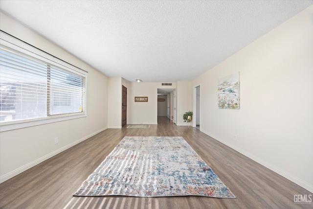 interior space with wood-type flooring and a textured ceiling