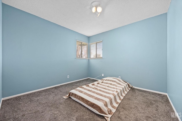 unfurnished bedroom with a textured ceiling and carpet flooring