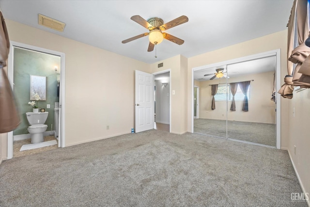 unfurnished bedroom with light carpet, a closet, ceiling fan, and ensuite bathroom