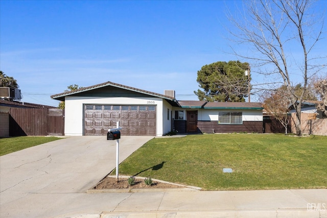 ranch-style house featuring a garage, a front yard, and central air condition unit