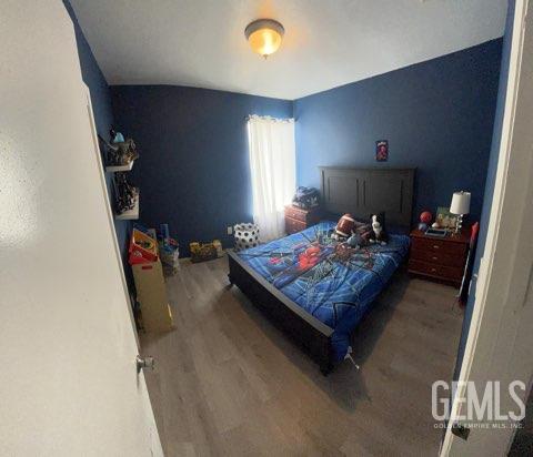 1024 Hazelnut St, Wasco, CA 93280 - bedroom with wood finished floors