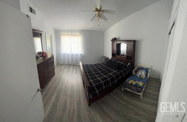 1024 Hazelnut St, Wasco, CA 93280 - bedroom featuring wood finished floors, lofted ceiling, and a ceiling fan