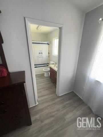 1024 Hazelnut St, Wasco, CA 93280 - full bath featuring vanity, wood finished floors, and toilet
