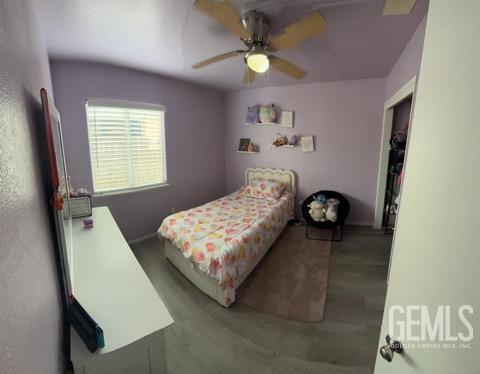 1024 Hazelnut St, Wasco, CA 93280 - bedroom with ceiling fan, wood finished floors, and baseboards