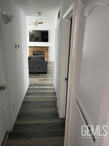 1024 Hazelnut St, Wasco, CA 93280 - corridor featuring wood finished floors and baseboards