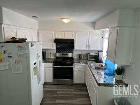 1024 Hazelnut St, Wasco, CA 93280 - kitchen featuring white refrigerator with ice dispenser, stainless steel range with gas stovetop, under cabinet range hood, a sink, and white cabinetry