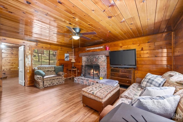 living room featuring hardwood / wood-style flooring, wood walls, wood ceiling, and a brick fireplace