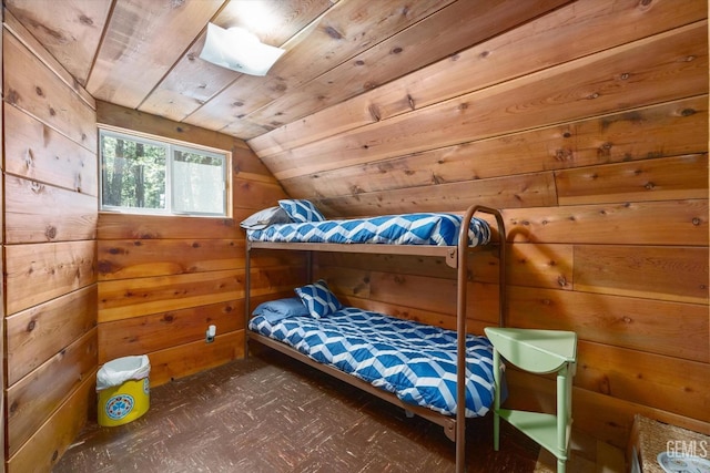 bedroom with lofted ceiling, wooden walls, and wood ceiling