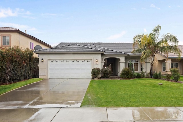 view of front of house with a garage, a front lawn, concrete driveway, and stucco siding