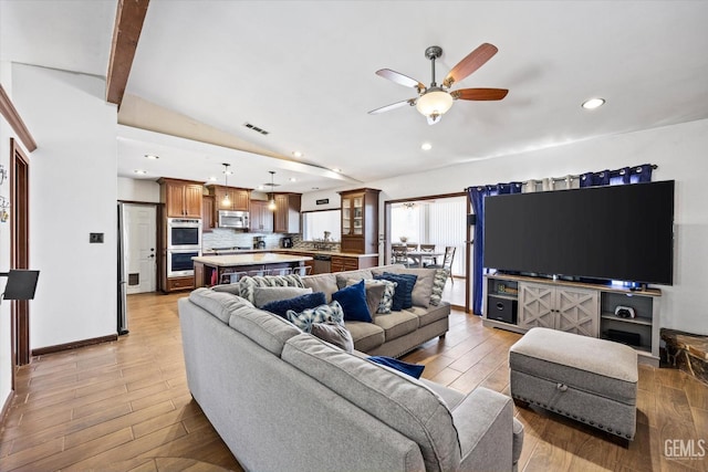 living room with vaulted ceiling with beams and ceiling fan